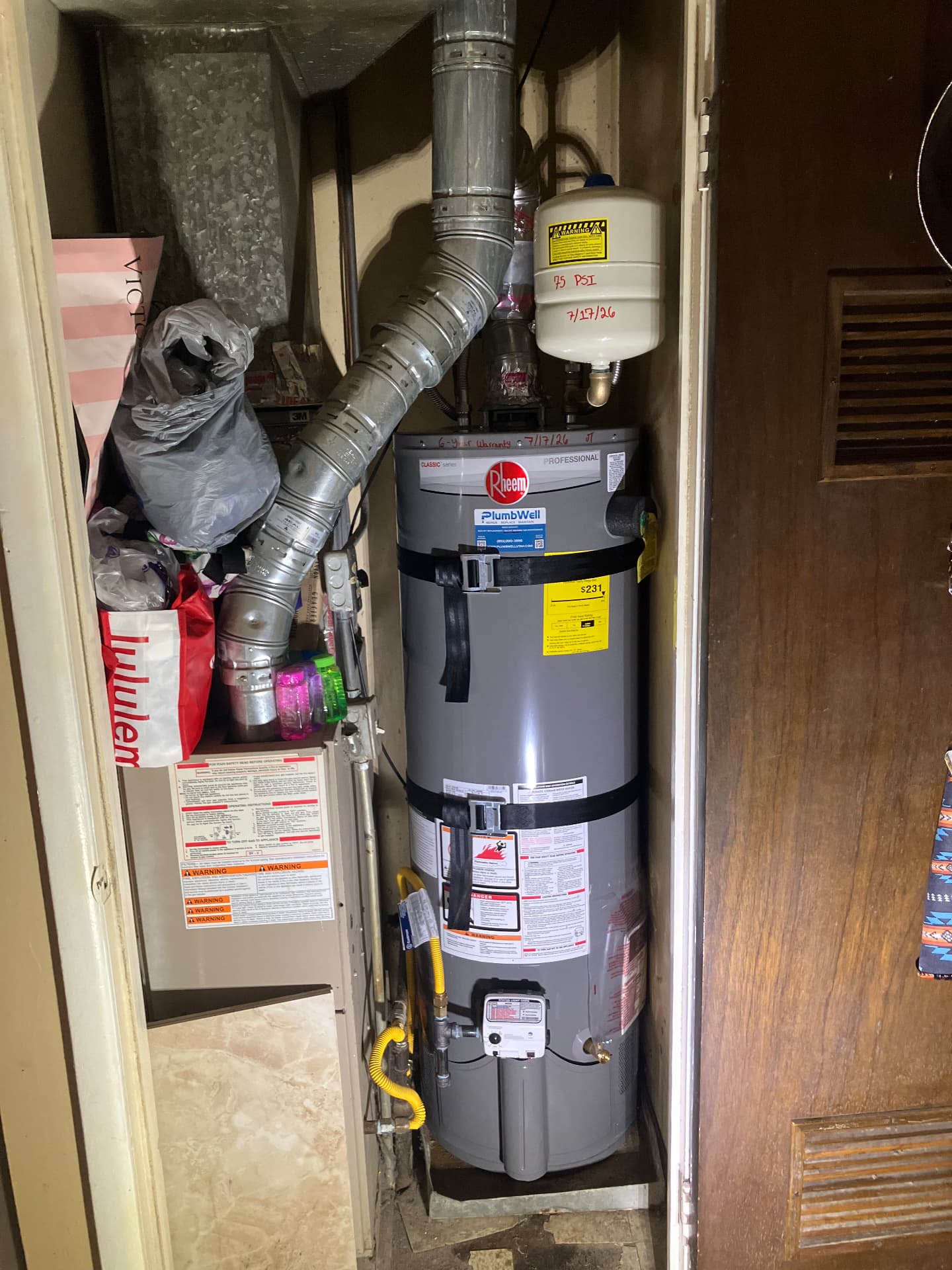 New Rheem water heater installed in a Utah utility closet with expansion tank and new venting