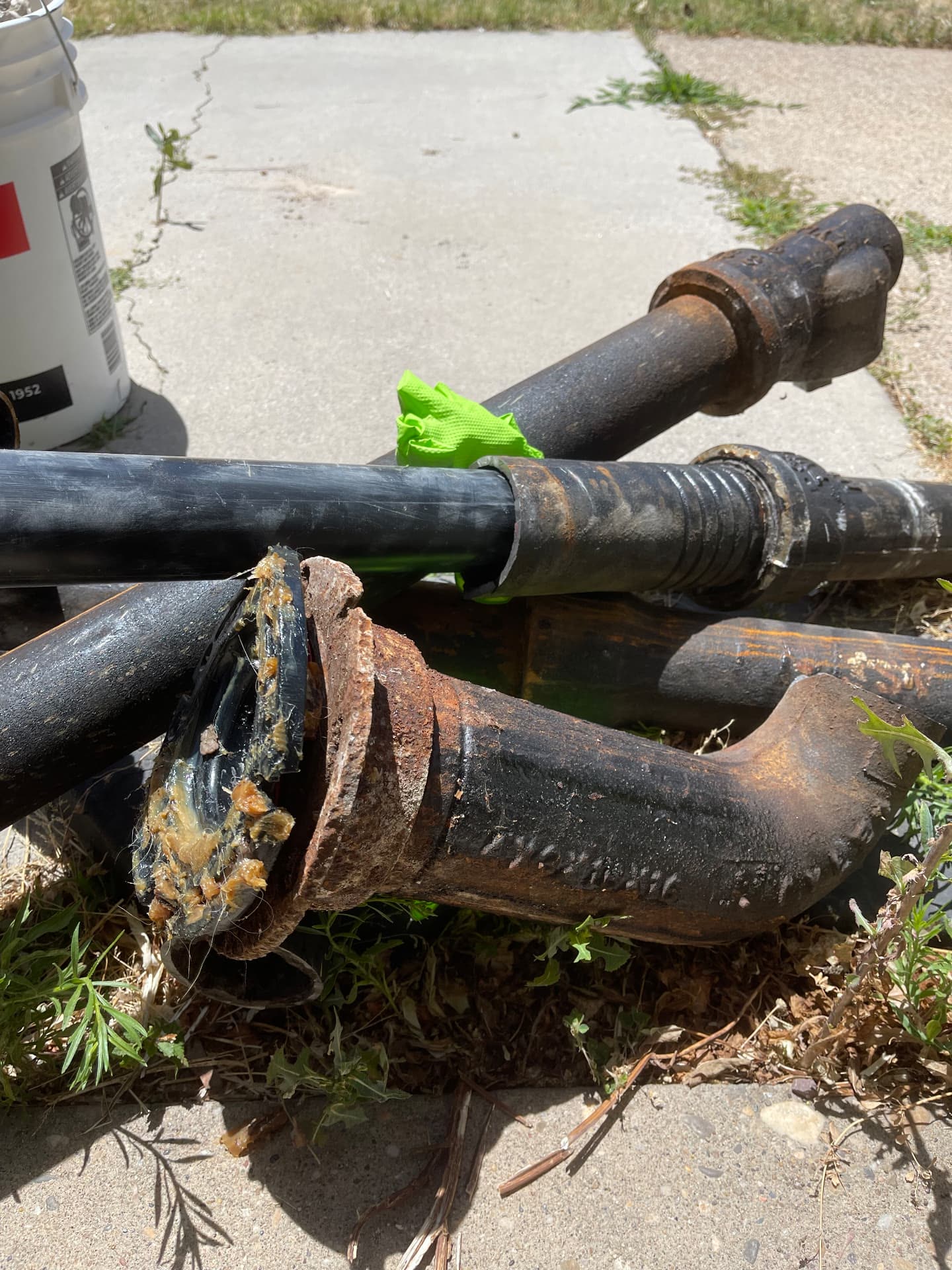 Pile of corroded cast iron drain pipe removed from a home during a repipe